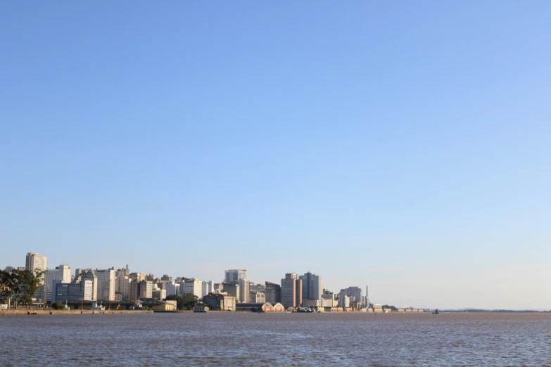 an airplane in the air over water with buildings