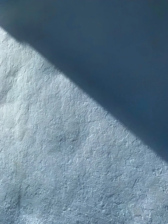 a person's shadow on the white surface