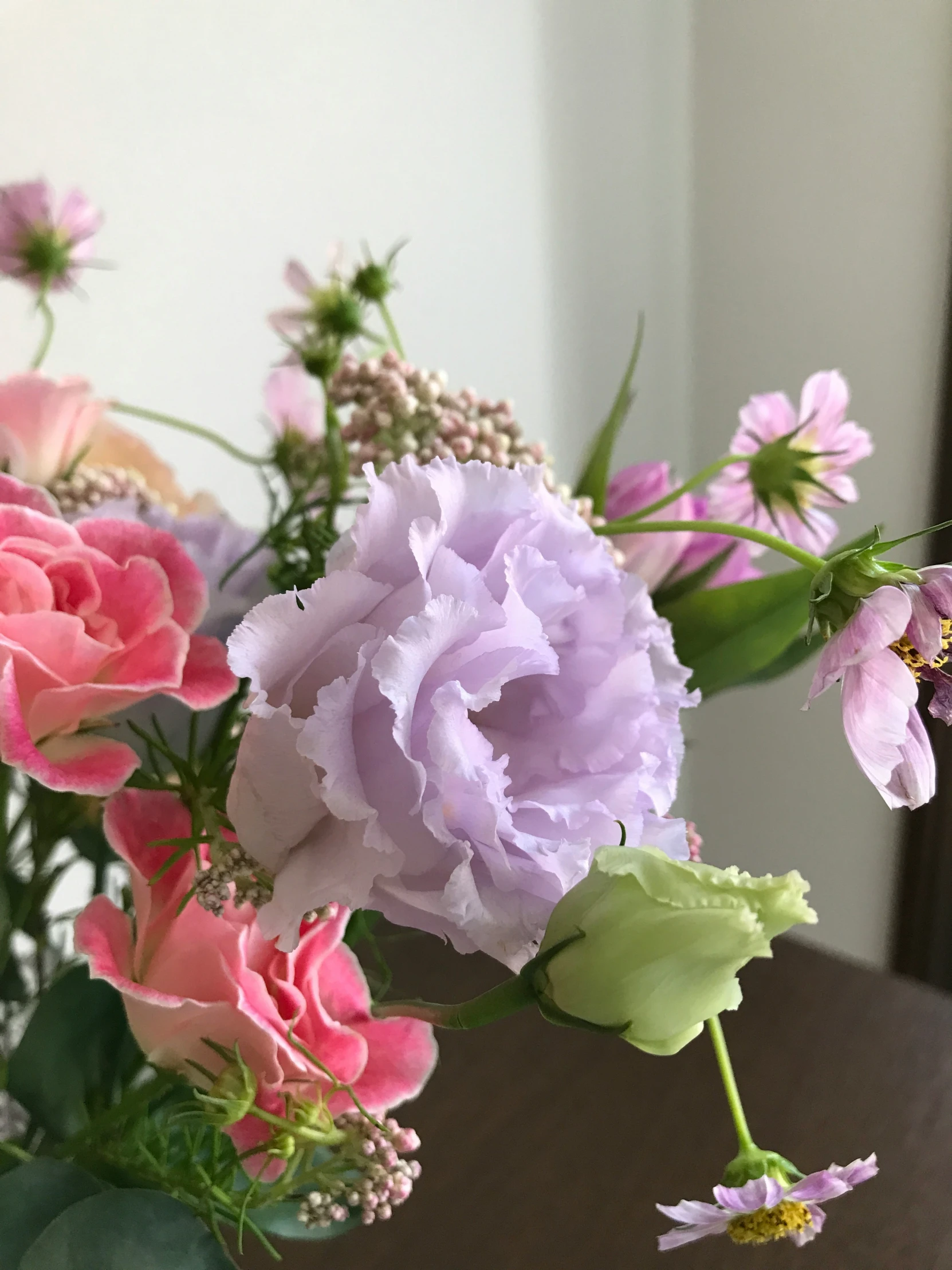 various types of flowers sit in a vase