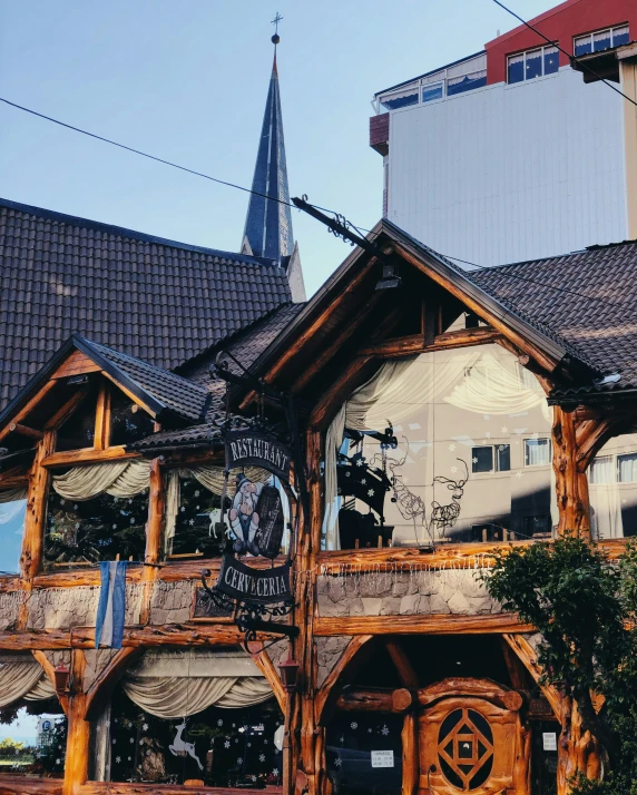 a clock tower stands on top of a wooden building