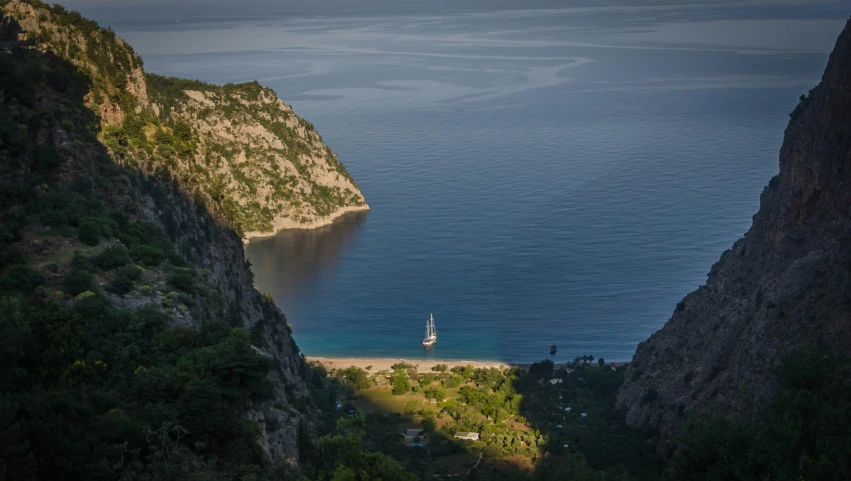 a boat is out in the water near the mountain