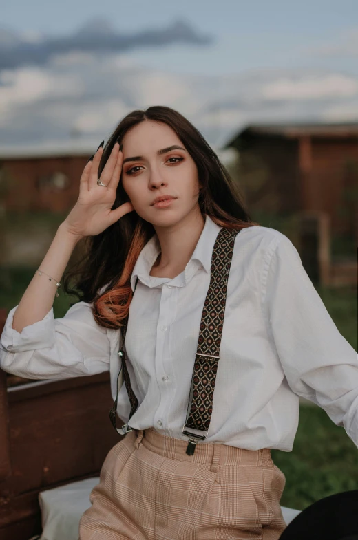 young lady with long hair wearing suspenders and a on - up shirt