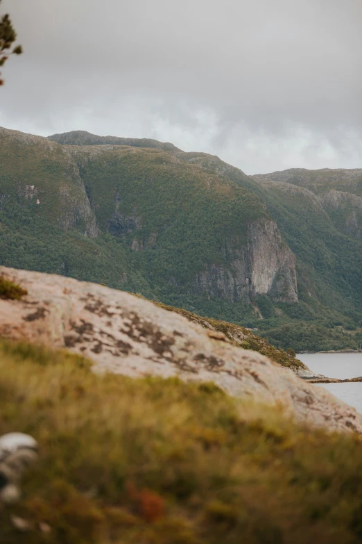 a lonely lone boat on the river near a mountain