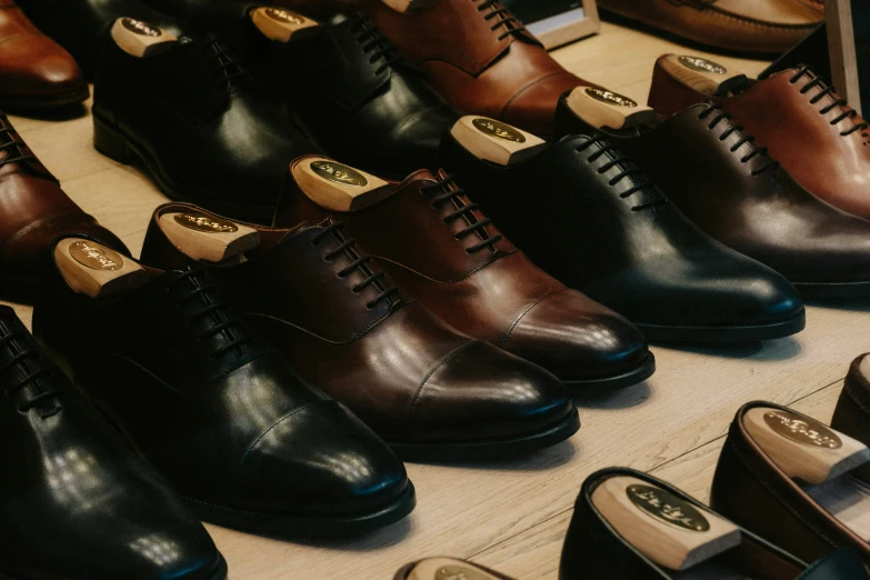 the brown shoes are lined up on the table