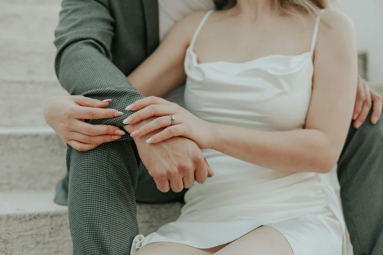 the couple is sitting on stairs together on their wedding day