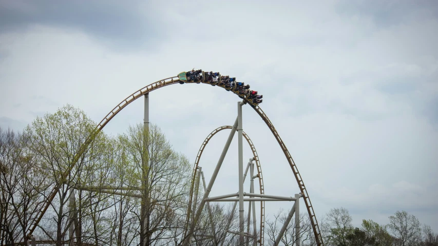 people ride in an amut park roller coaster