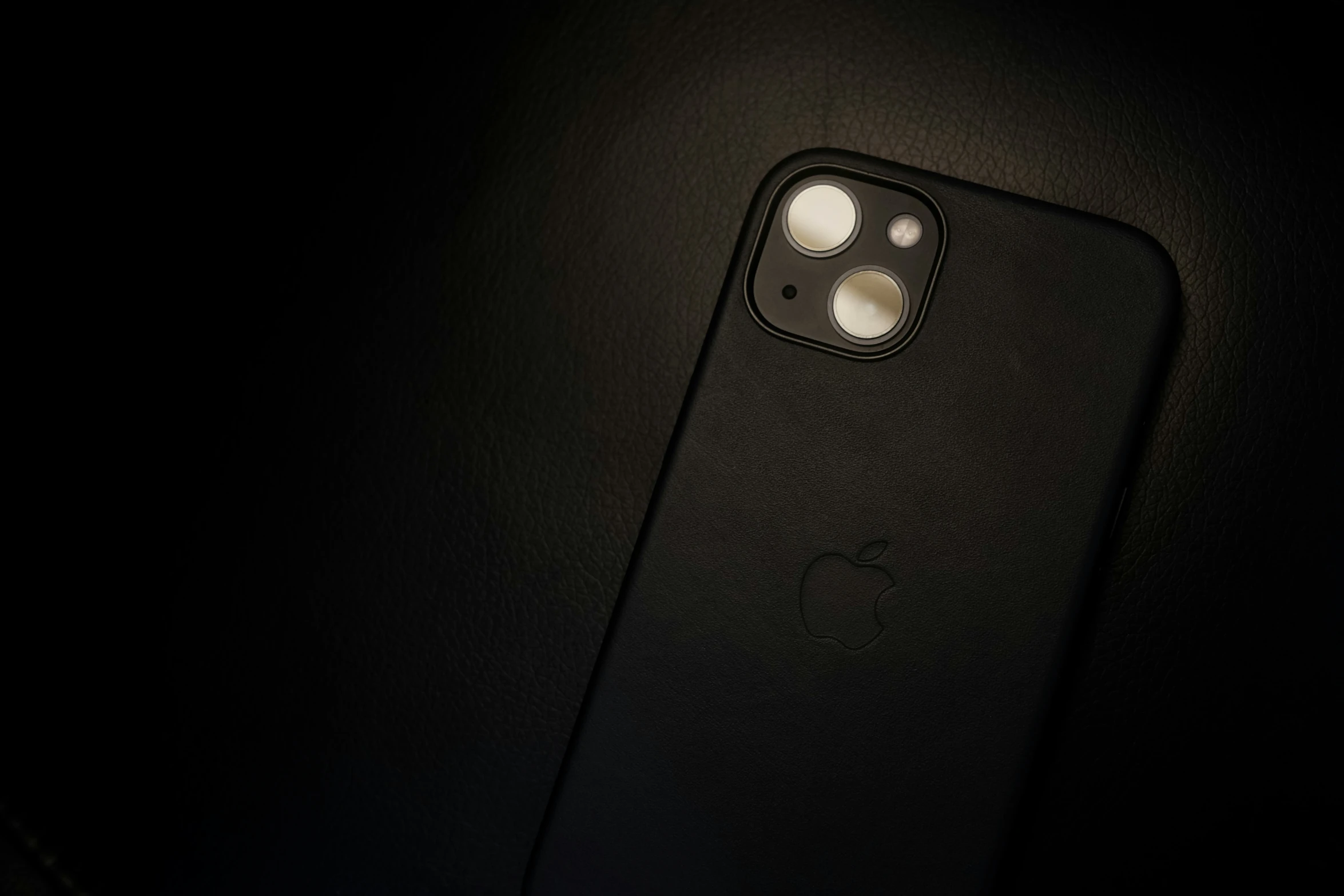 an iphone is on display in the dark