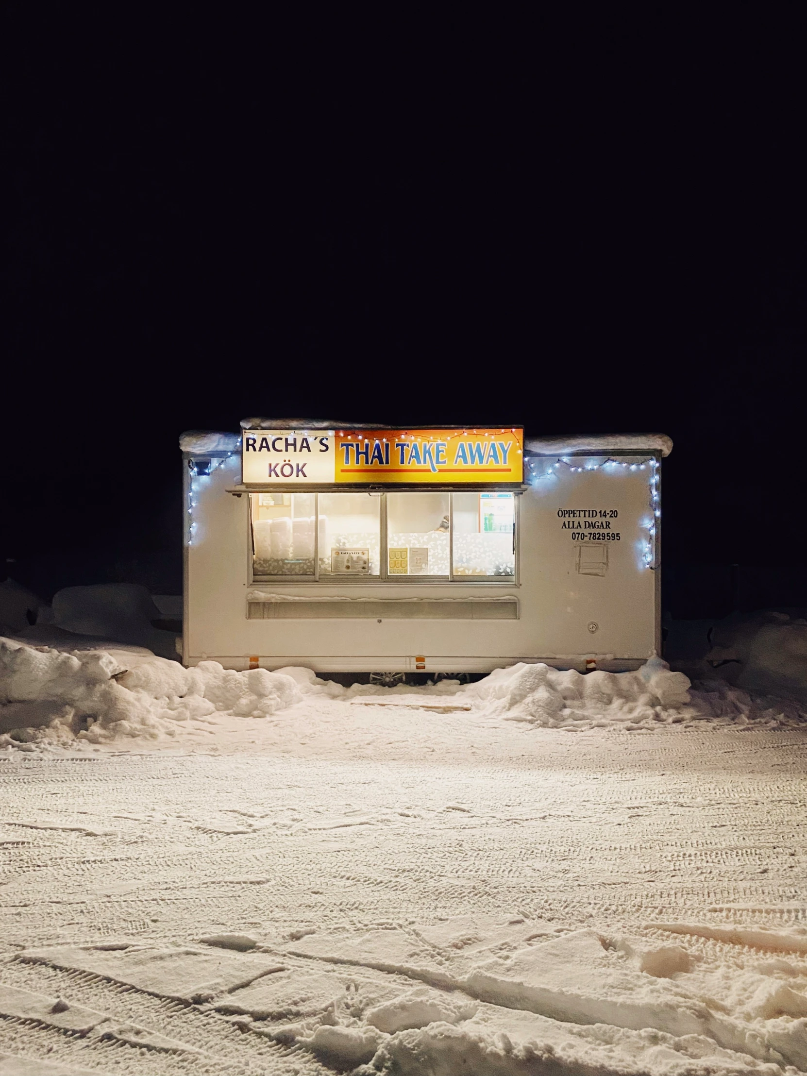 a small store with some snow on the ground