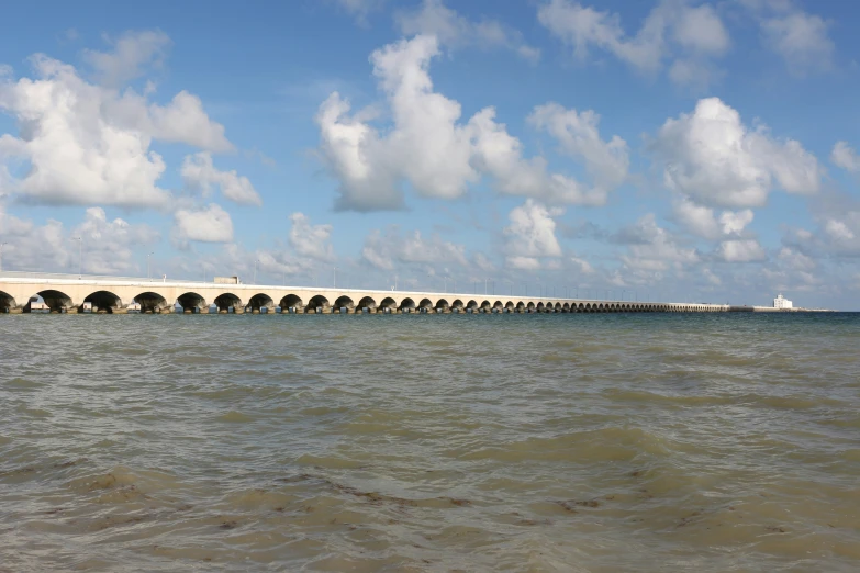 the water is very choppy in this view of a large bridge
