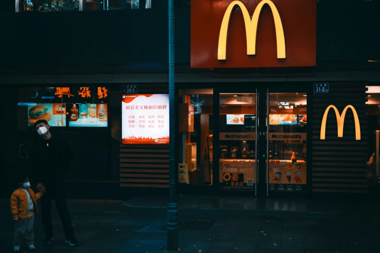 a person with a dog is standing next to a mcdonald's