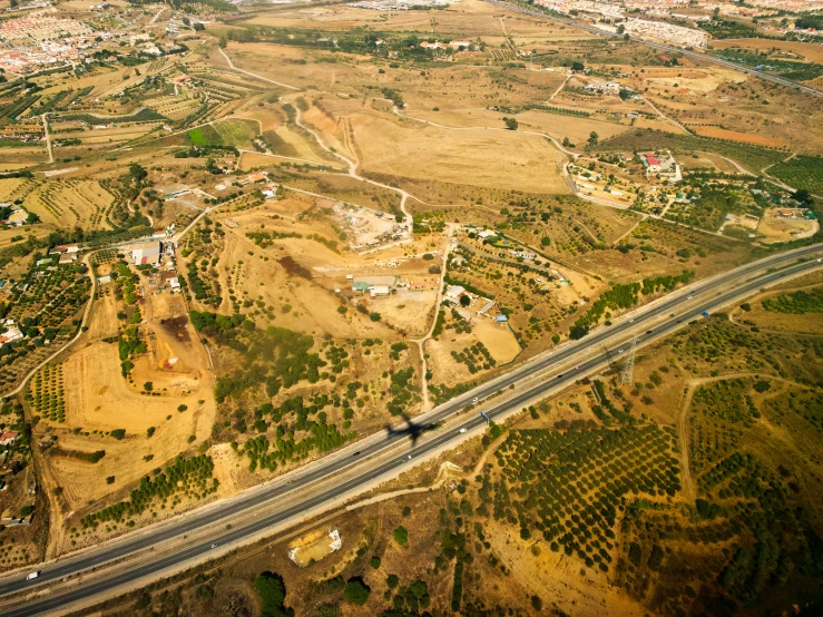 an aerial view of an overpass road in a town