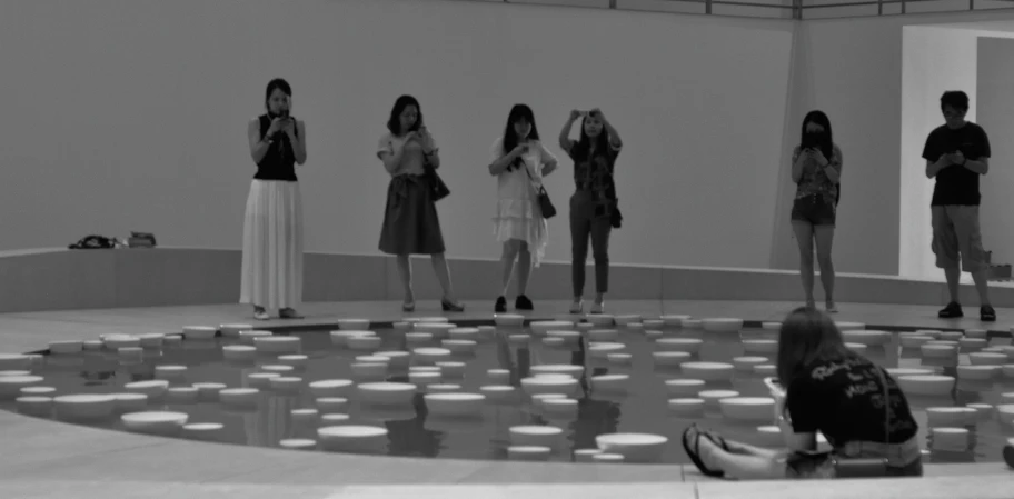 several women standing next to each other on the side of a large circle