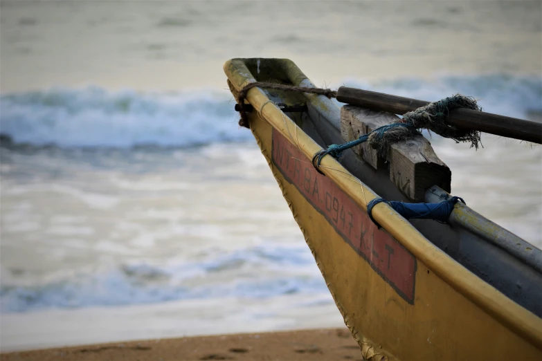 a close up of an old wooden boat with water behind it