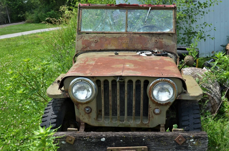 an old rusty truck is seen in a field