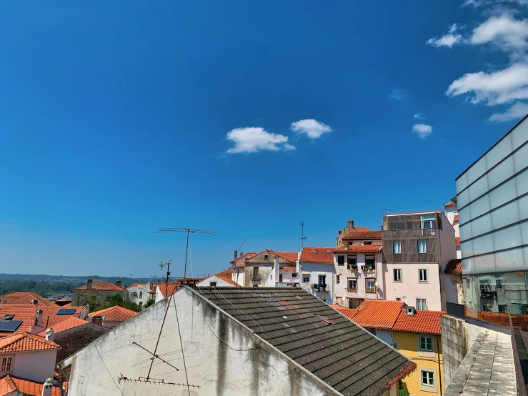 a bird is flying over the city of the day