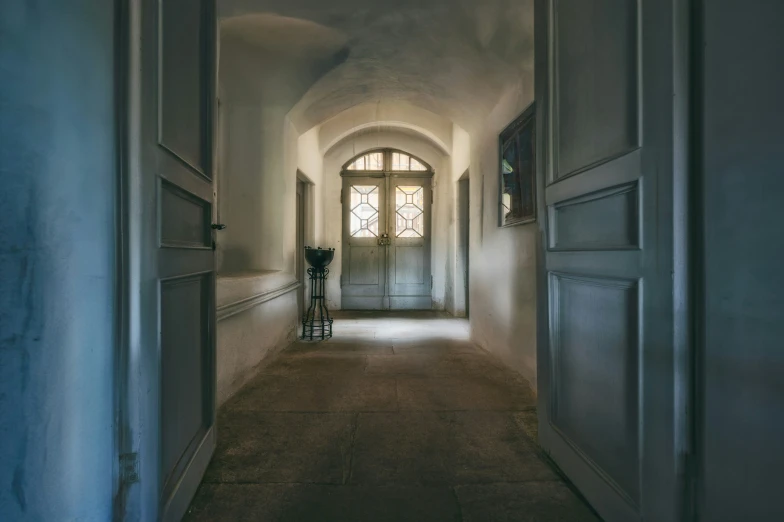 an archway with door leading to a big window