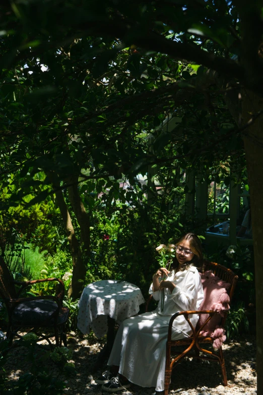 an image of a woman on the couch under a tree