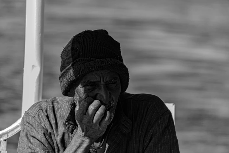 a black and white po of a man wearing a hat