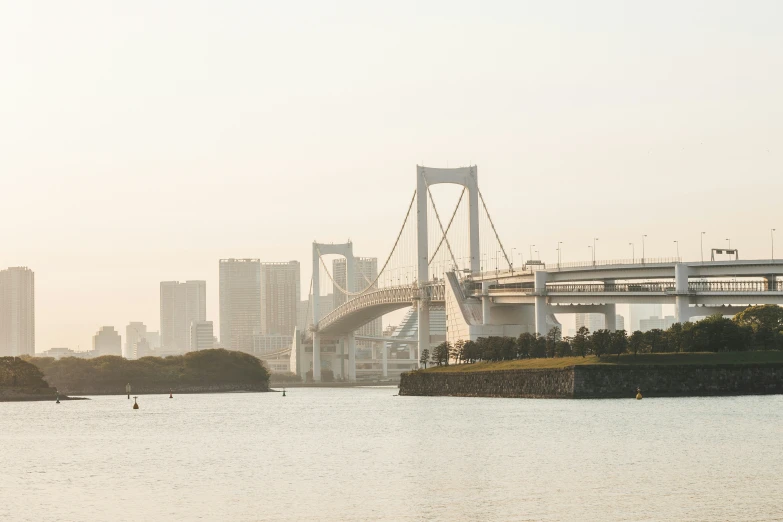 an bridge with boats in it next to a city