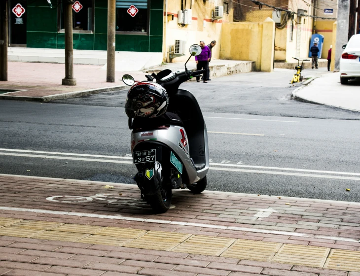 a motorcycle parked on a street corner on a street