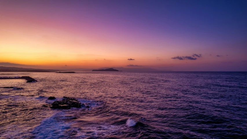 a po of some water and rocks during sunset