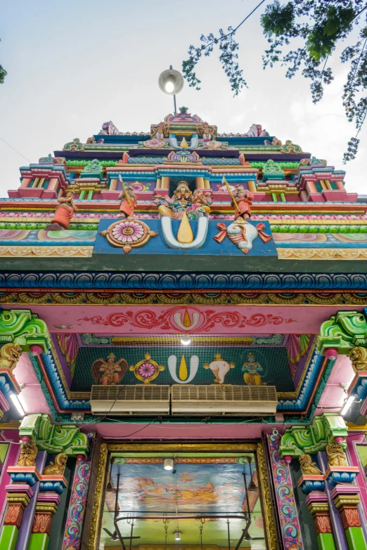 a tall building has multicolored architecture on top