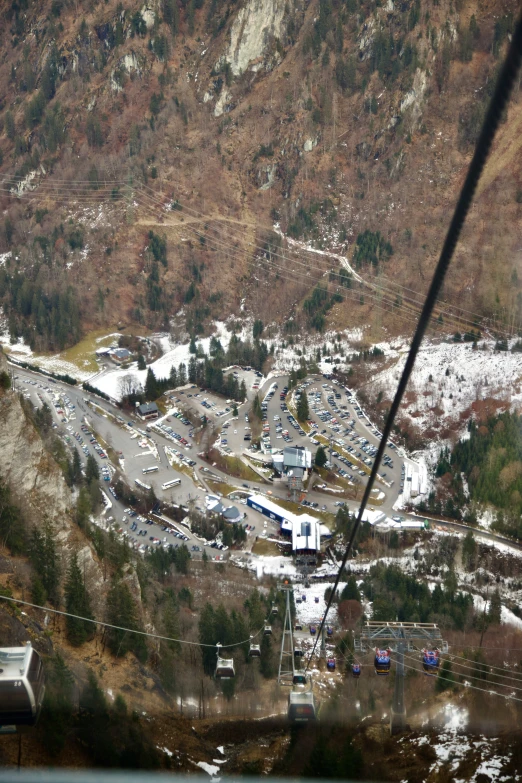 view from a cable car at an area with buildings and hills