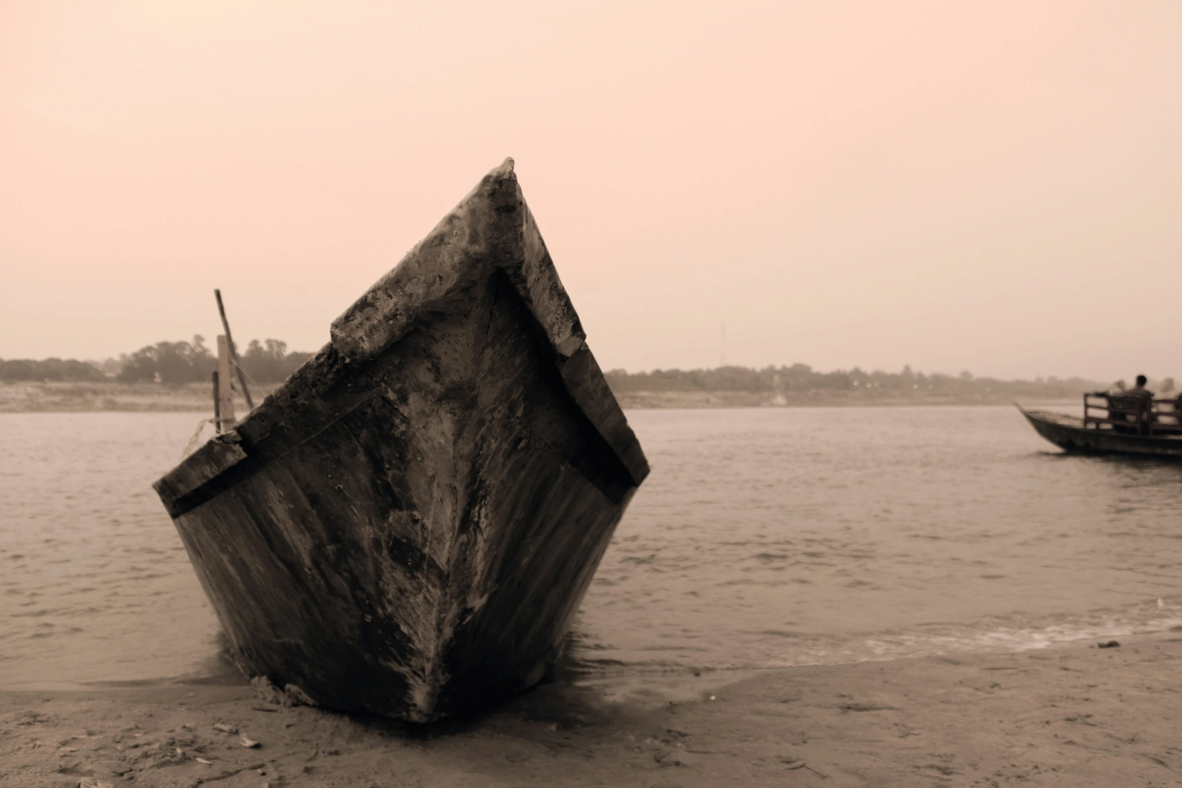 a old boat on the beach is out in the water