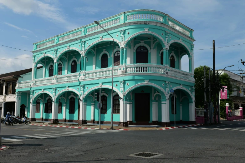 this is a po of a green building with a balcony