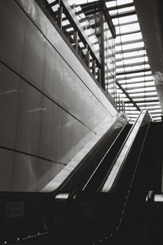 an escalator sits in front of a wall