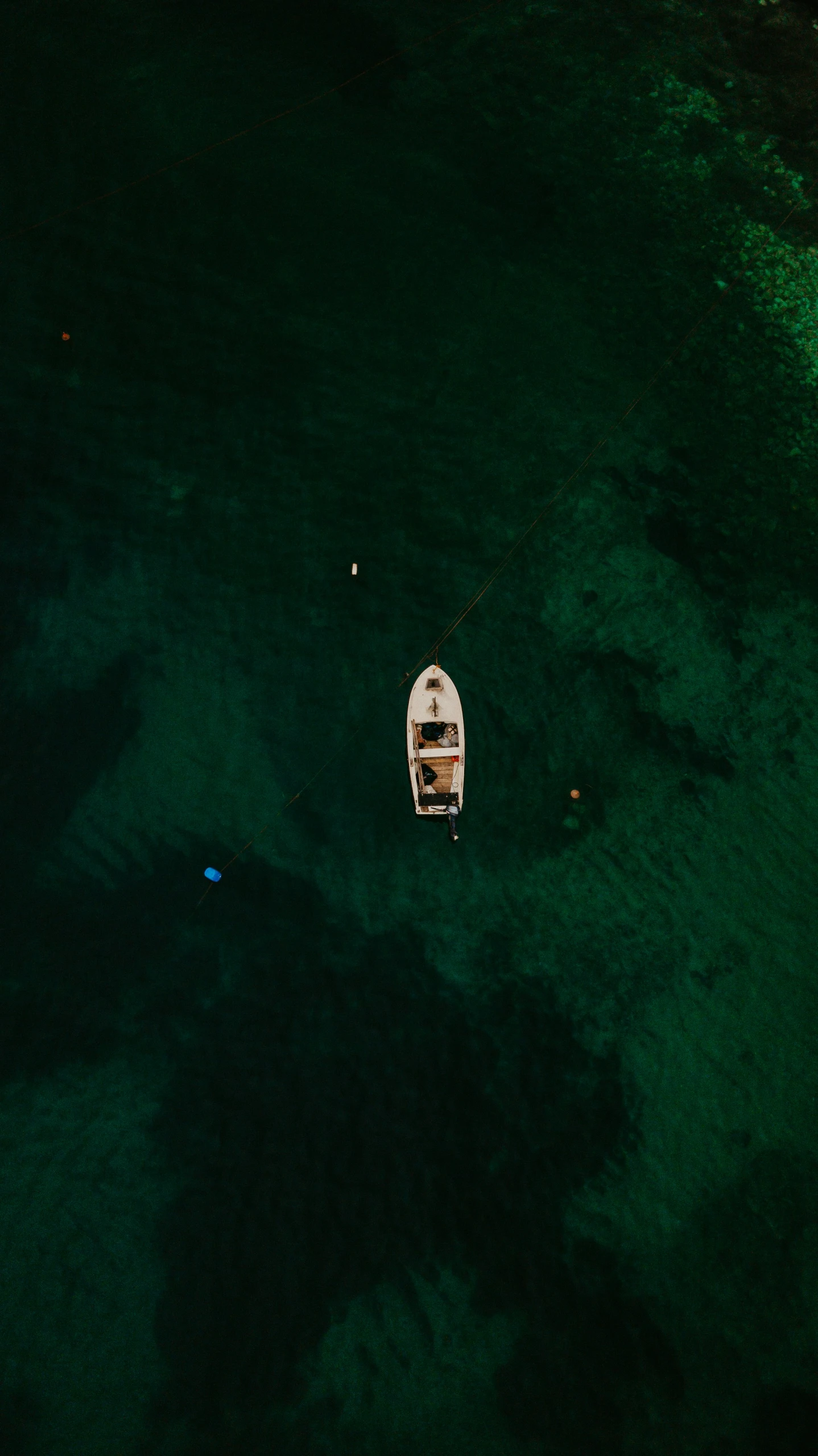 an aerial view of a small boat docked near the beach