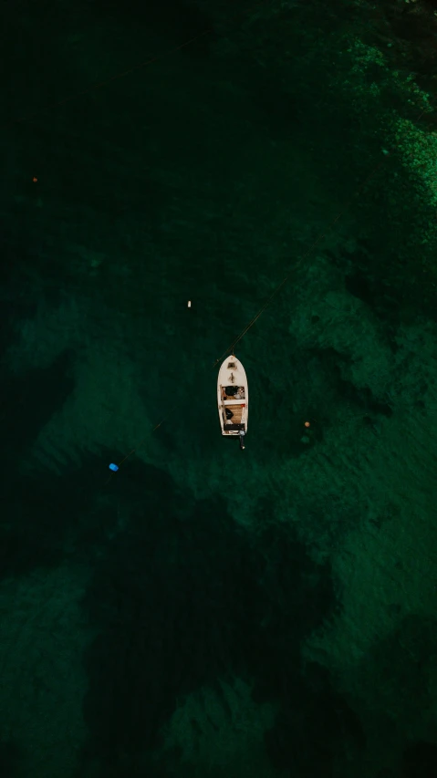 an aerial view of a small boat docked near the beach