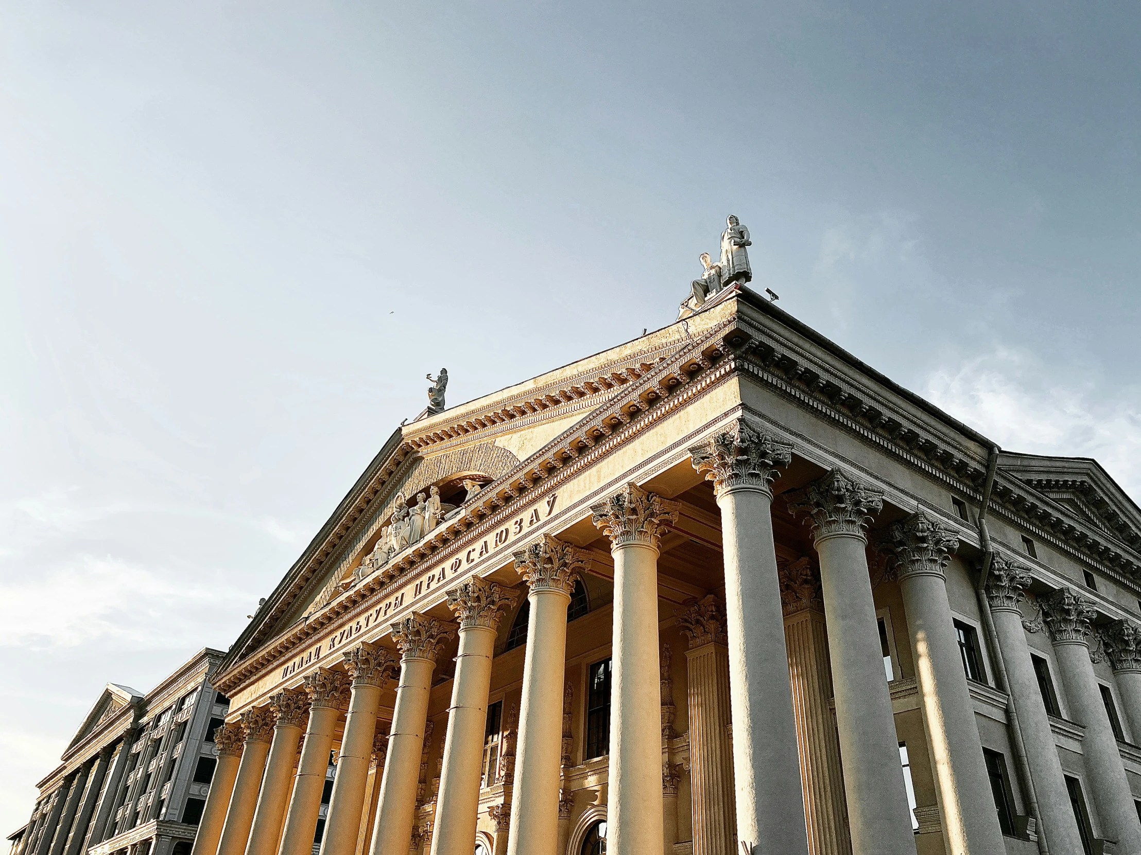 the facade of an ornate building on a sunny day