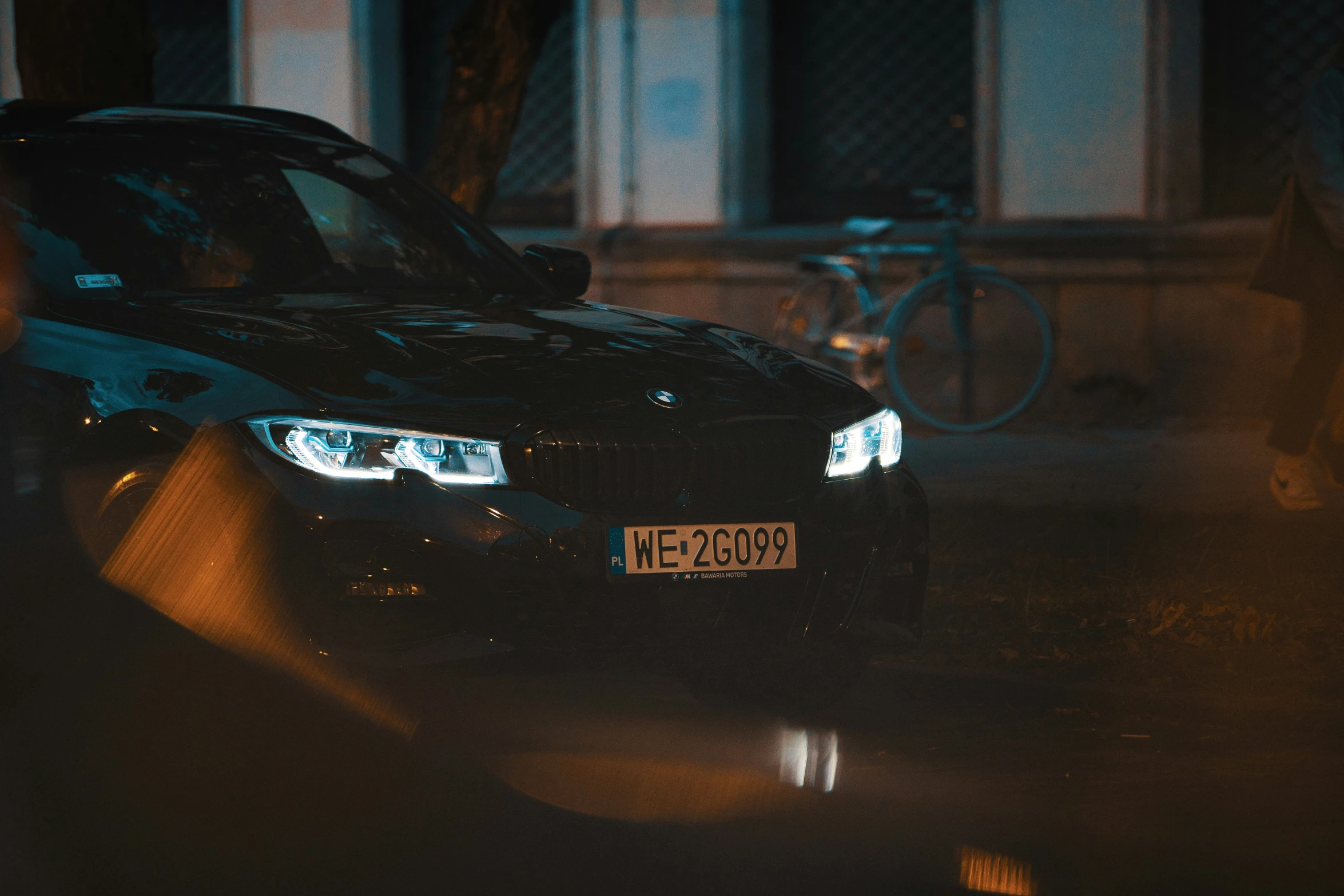 a car parked on a wet road at night