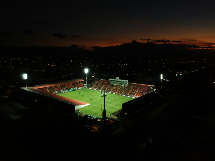 a soccer field sitting below some bright lights