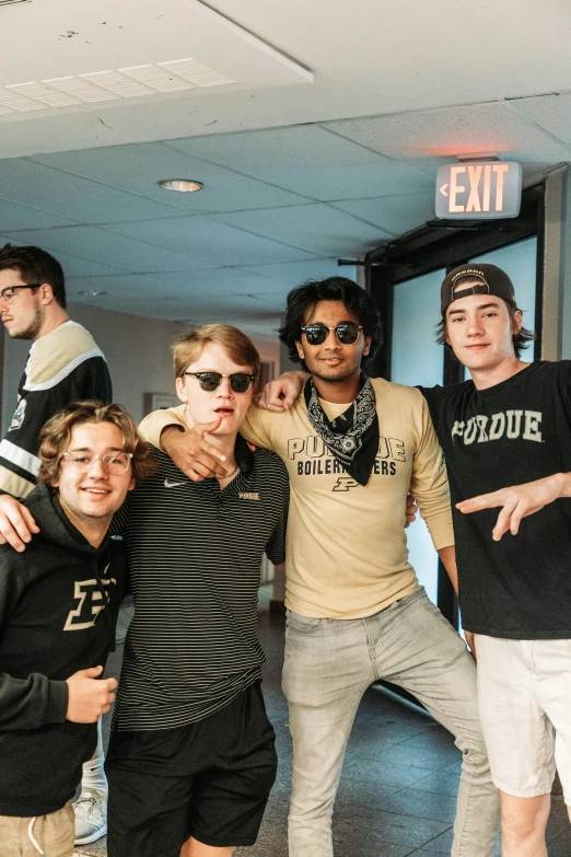 some guys posing for the camera and wearing sunglasses