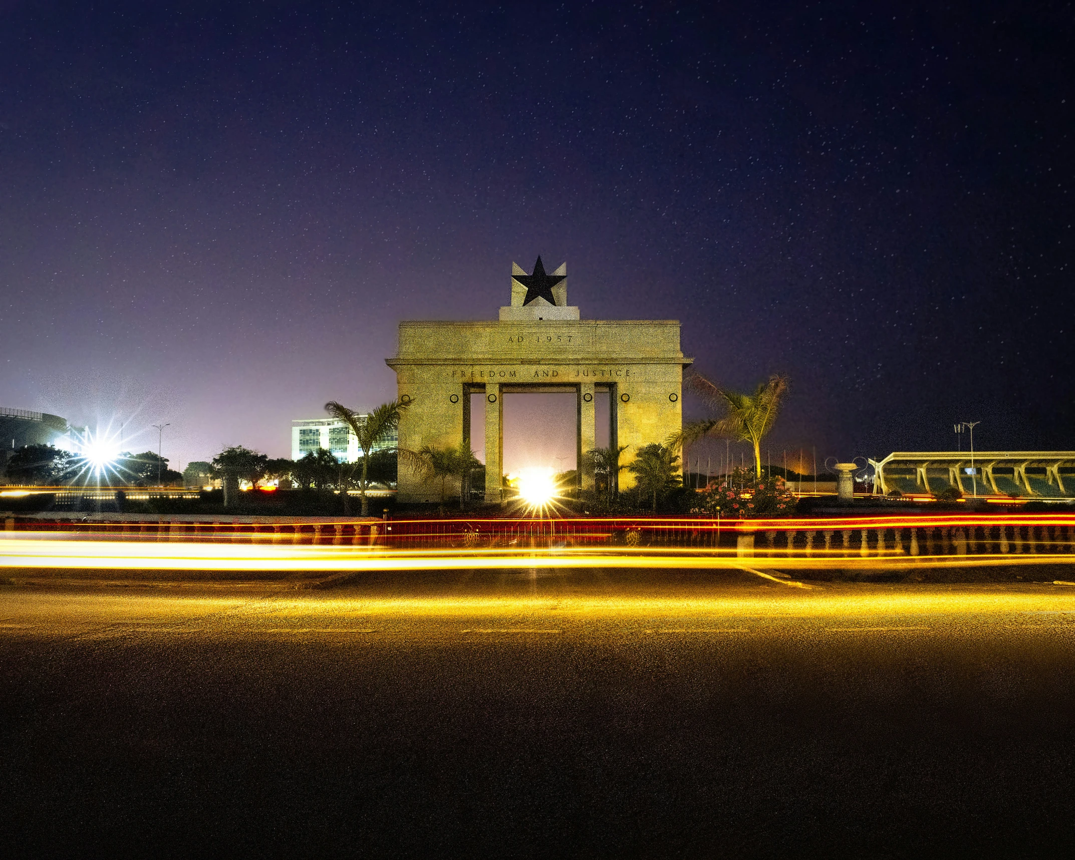 traffic passes near the war memorial at night