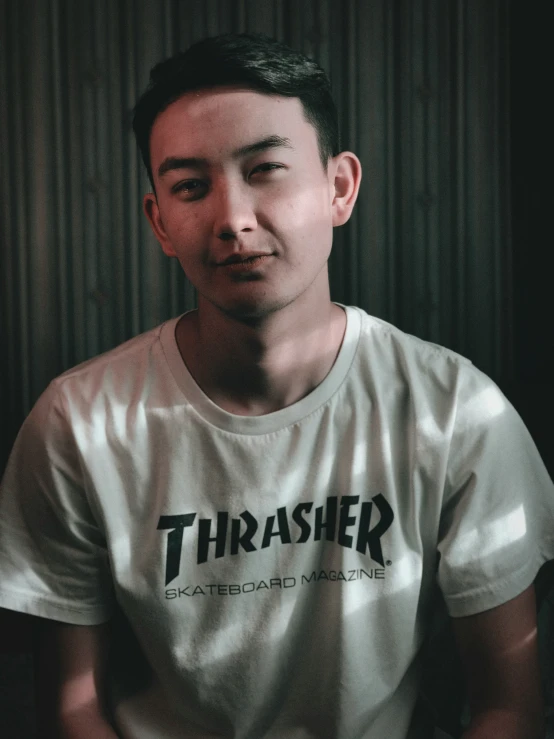 a guy posing for a po while wearing his thrash shirt