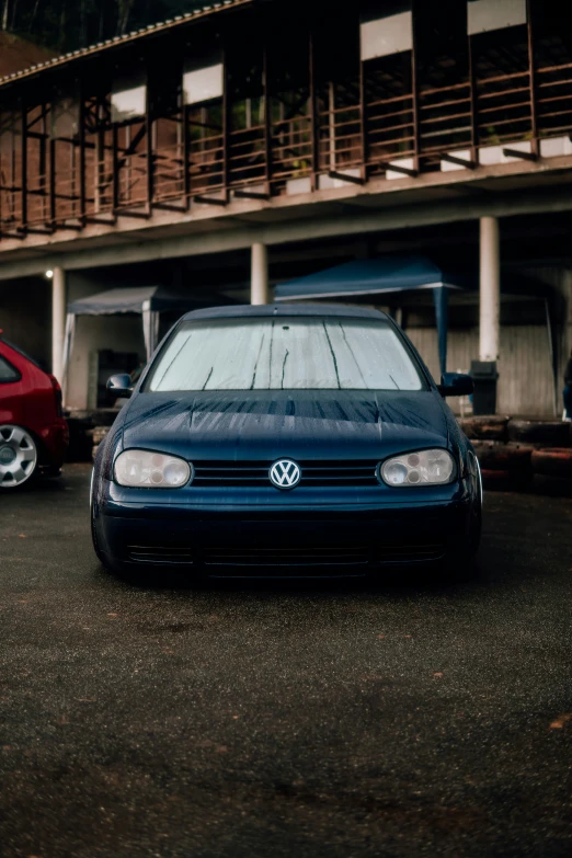 the vw golf is parked in front of the building