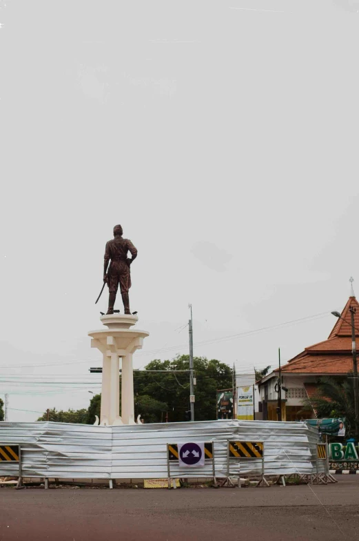 a man standing on top of a giant statue