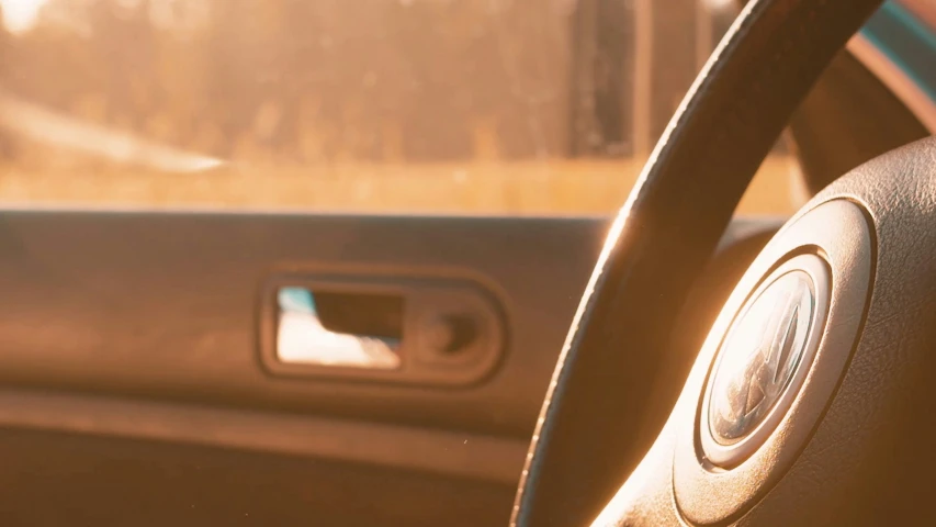 the steering wheel of a car with a blurry background