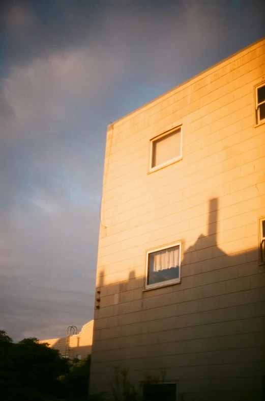 the building has two windows and shadows from it