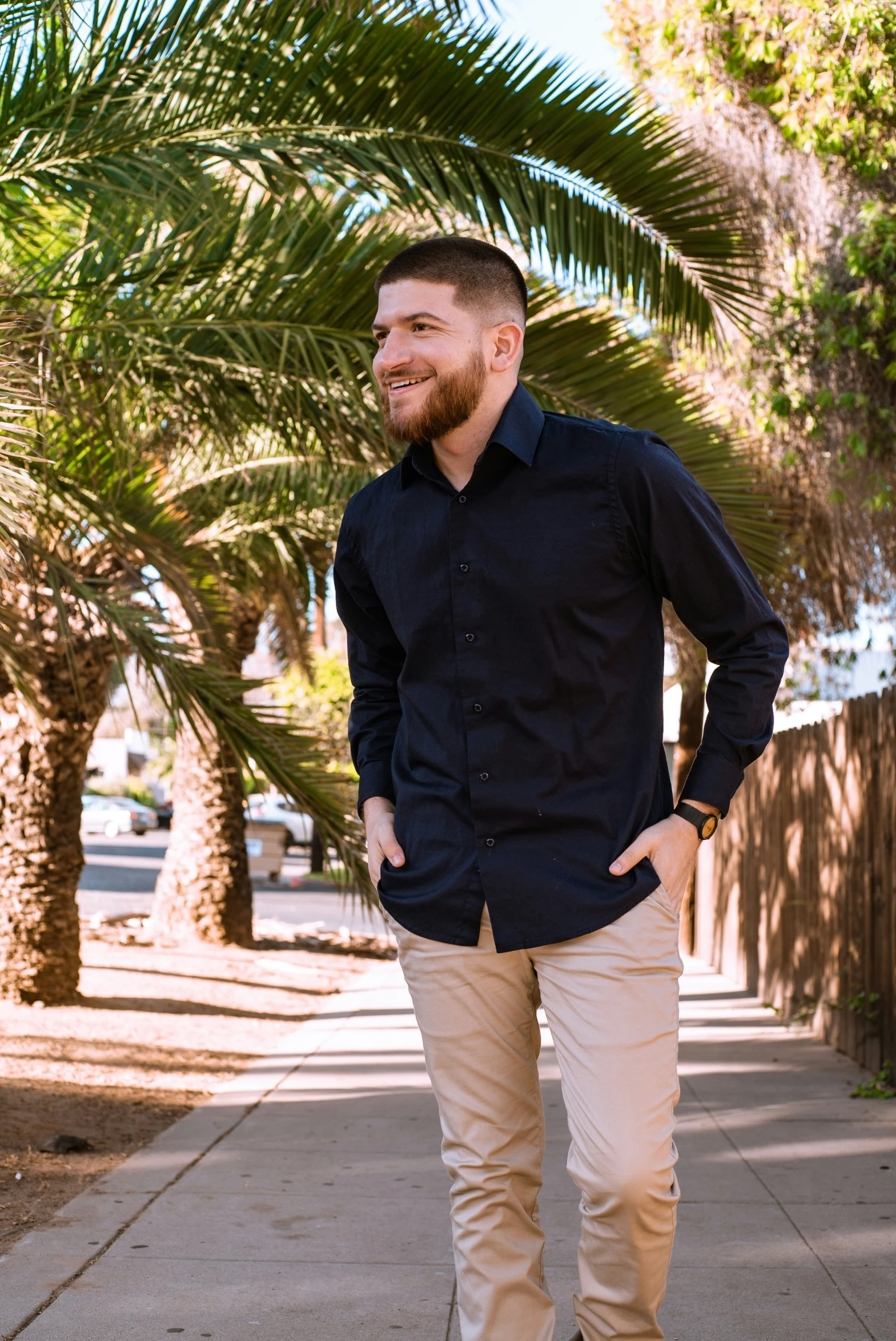 a man standing on the sidewalk looking down