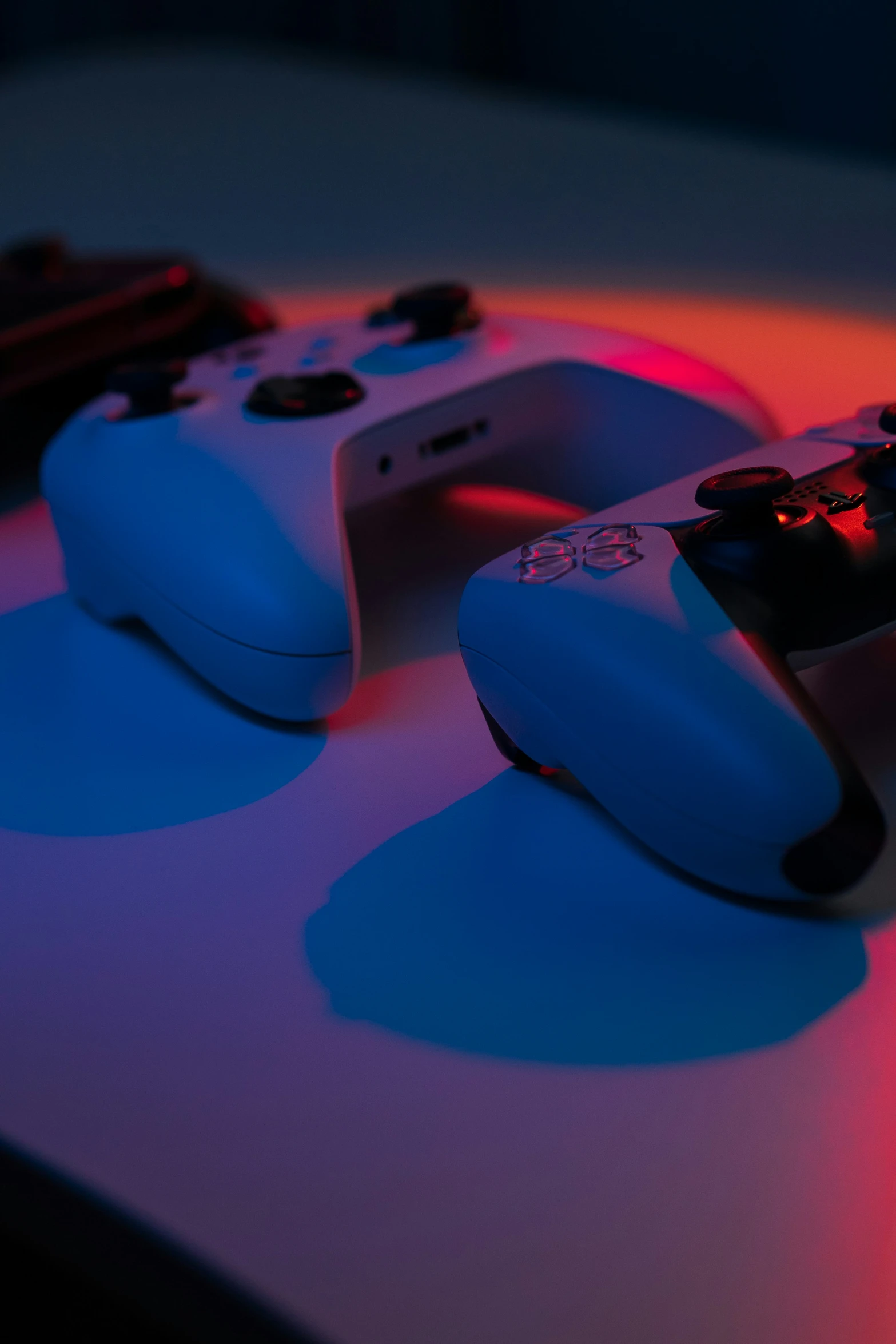 two controllers illuminated at different angles in bright light