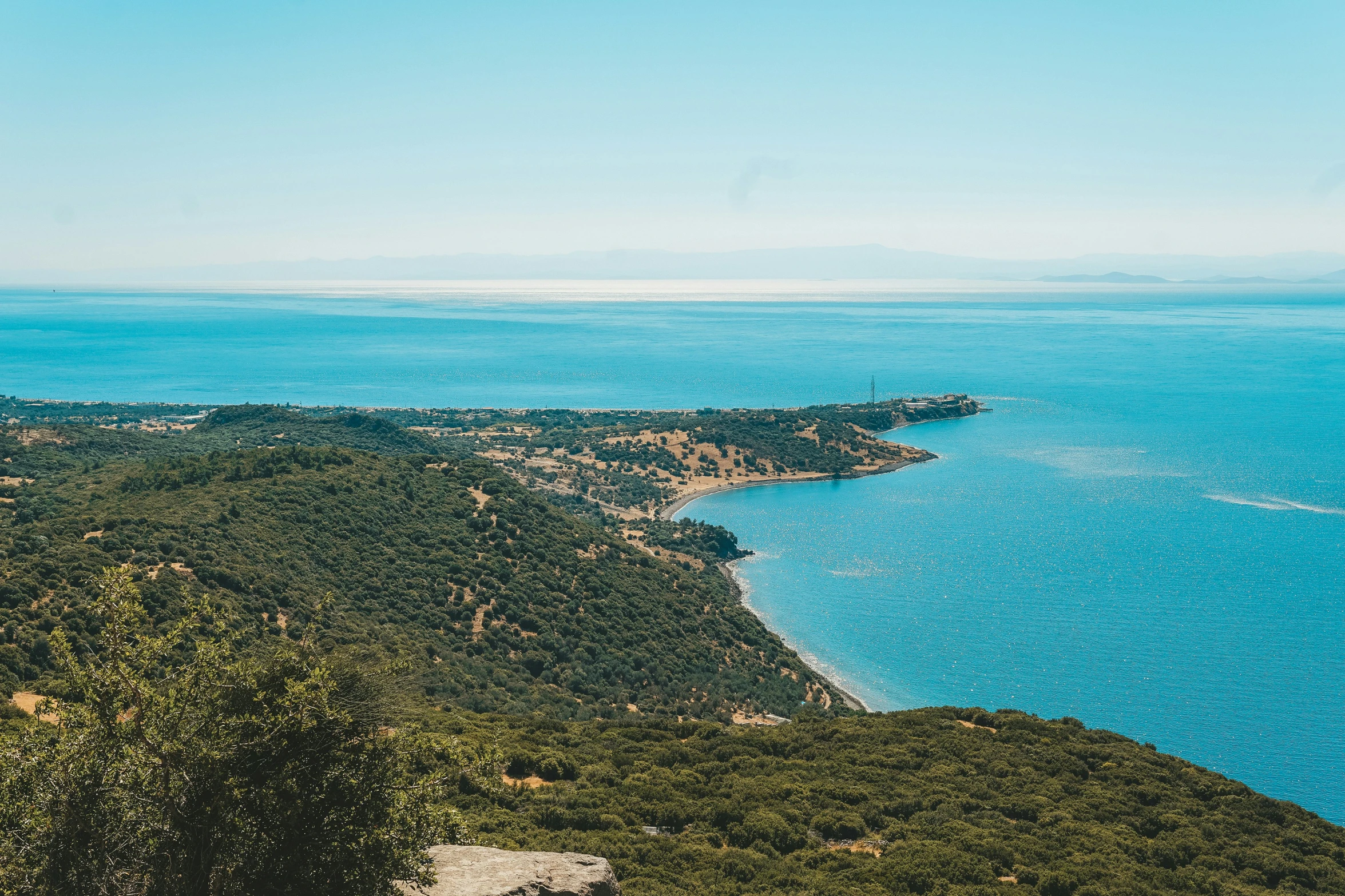 a body of water near land on a hill