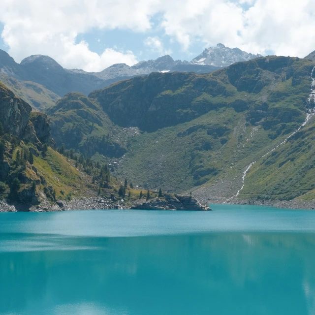 a lake is surrounded by mountains and trees