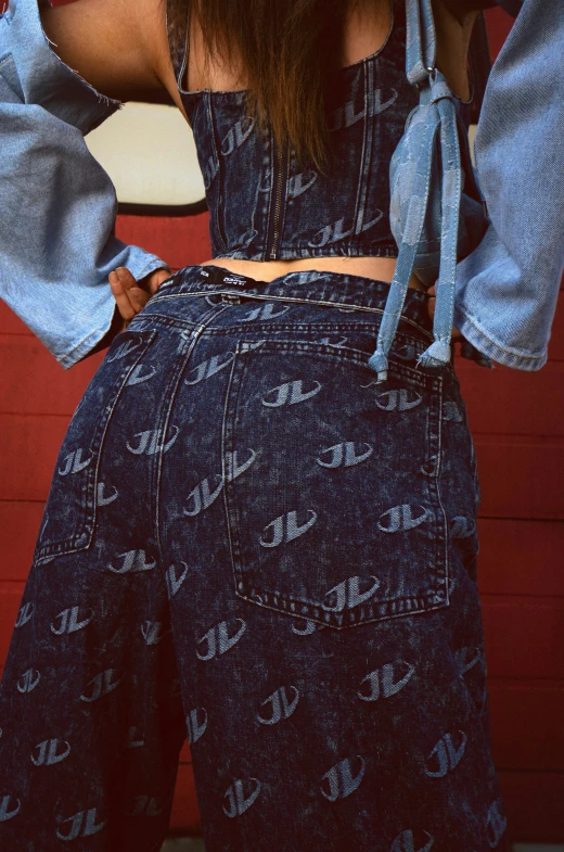 woman's back, wearing denim overalls and wide collared shirt