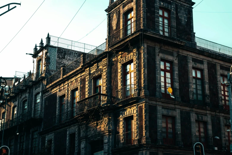 a brown building with some windows and buildings