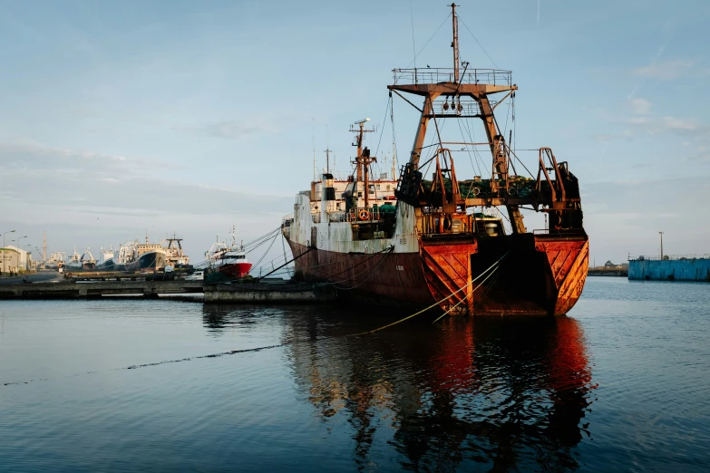 the large ships are in a harbor by the shore