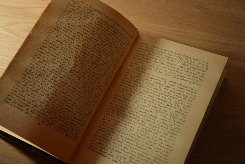 an open book sits on a wooden table